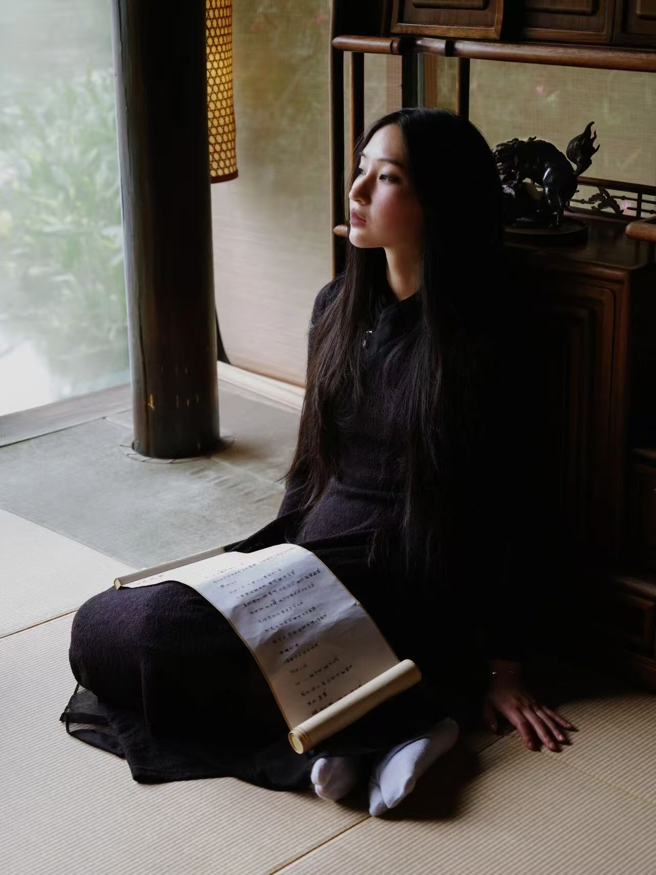 Poet and vocal artist Ting with a scroll of Chinese poetry