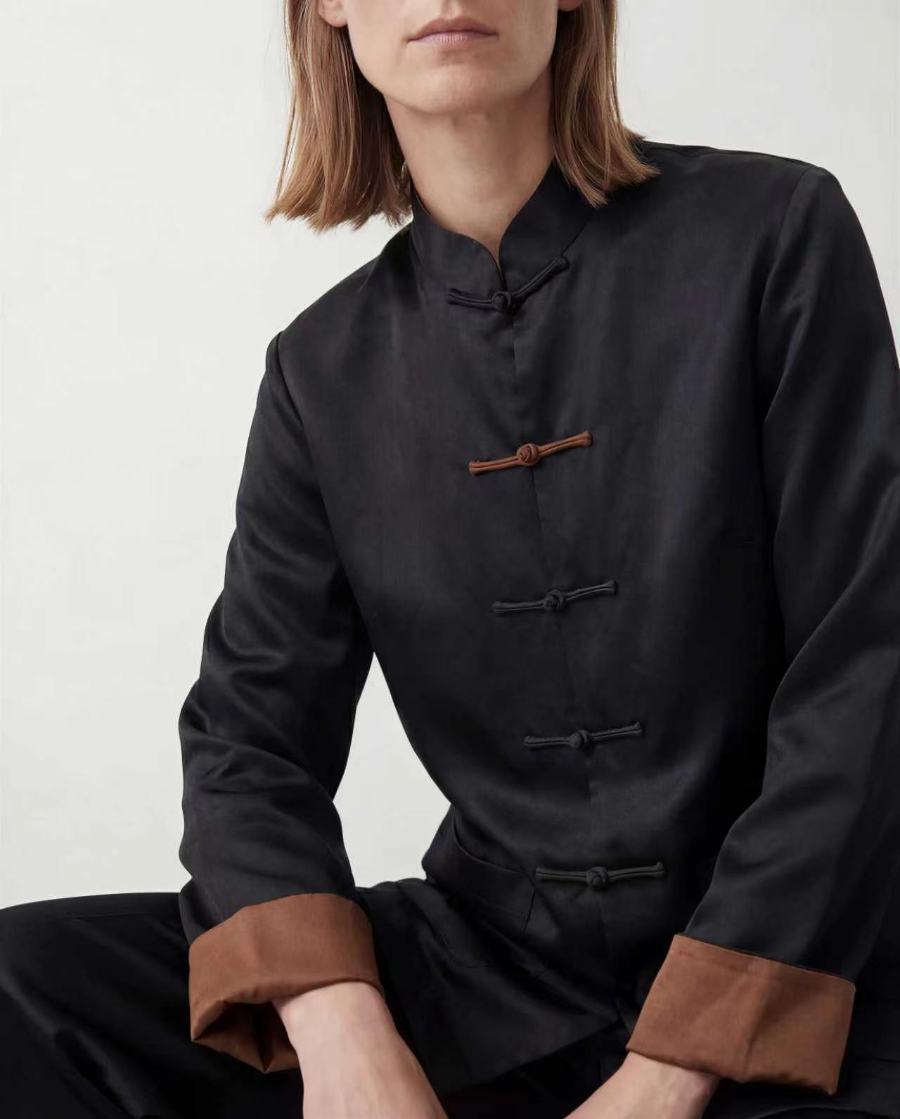 Black side of the reversible jacket, with traditional knotted closures